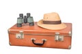 Travel and adventure concept. Vintage brown suitcase with binoculars and fedora hat isolated on white Royalty Free Stock Photo