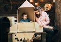 Travel and adventure. Father and small boy in paper rocket. Family and childhood. Earth day concept. father day. Dream