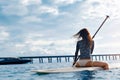 Travel Adventure. Woman Paddling On Surfing Board.