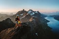 Travel adventures in Norway: family hiking in mountains outdoor parents and child on the top enjoying Kvaloya landscape Royalty Free Stock Photo