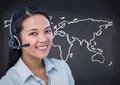 Travel agent with headset against white map and navy chalkboard Royalty Free Stock Photo