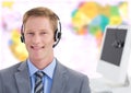 Travel agent man wearing headset in front of world map Royalty Free Stock Photo