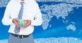 Travel agent mid section holding globe against map with clouds and blue background