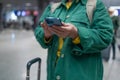 Travel, airport senior 60s woman in comfy casual outfit going vacation alone, holding a smartphone and booking cheap Royalty Free Stock Photo