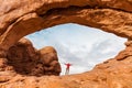 Travel In Arches National Park, Man Hiker With Backpack In North Window, Utah, USA
