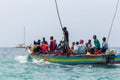 Travel around Africa. Boat full of African people floating on the waves.