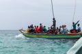 Travel around Africa. Boat full of African people floating on the waves.