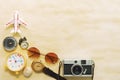 Travel background concept. Camera, sunglasses, compass and airplane model on wood table with free space for text Royalty Free Stock Photo