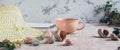 Travel background, hat, shells, stones and cup of coffee on table web banner Royalty Free Stock Photo