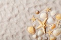 Travel background from sandy beach decorated with starfish and seashell. Top view. Royalty Free Stock Photo