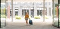 travel background, woman tourist walking with suitcase on the street in european city, tourism in Europe Royalty Free Stock Photo