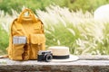 Travel backpack with traveler items on wooden bench with nature background Royalty Free Stock Photo