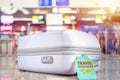 travel bag at the airport with travel insurance tag on suitcase holder for cover delay or lost luggage, trip cancellation Royalty Free Stock Photo