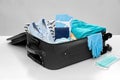 Travel bag packed with clothes, gloves and masks Royalty Free Stock Photo