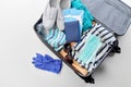 Travel bag packed with clothes, gloves and masks Royalty Free Stock Photo