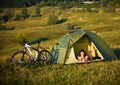 Travel with bicycle alone - young woman in the tent Royalty Free Stock Photo