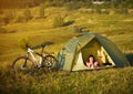 Travel with bicycle alone - young woman in the tent Royalty Free Stock Photo