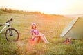 Travel with bicycle alone - young woman in the tent Royalty Free Stock Photo