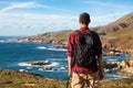 Travel in Big Sur, man Hiker with backpack enjoying view coastline pacific ocean, California, USA