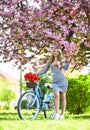 Travel by bike. Weekend concept. Spring holidays. Riding bicycle. Excursion to garden. Girl and sakura blossom. Cycling Royalty Free Stock Photo