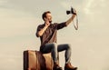 Travel blog. Man sit on suitcase. Handsome guy traveler retro camera. Travel with luggage. Travel blogger. Shooting vlog