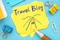 Travel Blog sign on the piece of paper