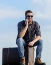 Travel blogger. Man sit on suitcase before journey. Business trip. Handsome guy traveler. Guy outdoors with vintage Royalty Free Stock Photo