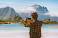 Travel blogger man taking photo by smartphone in Norway influencer outdoor