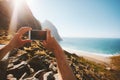 Travel blogger taking photo by smartphone influencer lifestyle summer vacations