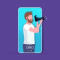 Travel blogger using digital camera man photographer taking photo blogging shooting vlog concept portrait smartphone