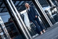 Travel, business trip. Woman in a suit walking out of airport Royalty Free Stock Photo