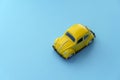 Travel car concept background. Yellow toy car on empty minimal pastel background. Driving, riding, road idea Royalty Free Stock Photo