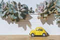 Travel car concept. Toy yellow car moves on against the backdrop of nature. Driving, adventure, discovery idea Royalty Free Stock Photo