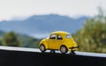 Travel car concept. Toy yellow car moves on against the backdrop of nature. Driving, adventure, discovery idea Royalty Free Stock Photo