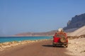 Travel by car on the unique island of Socotra. Car on a desert road along the coast