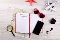 Map, phone, open notebook for to do list and other travel accessories. Royalty Free Stock Photo