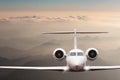 Travel concept. Airplane fly over clouds and Alps mountain on sunset. Front view of a big passenger or cargo aircraft Royalty Free Stock Photo