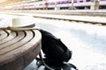 Travel concept. Backpack with hat at the train station