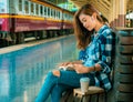Travel concept.beautiful girl reading book wating train