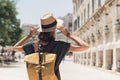 Travel concept, beautiful traveler woman walking in Corfu old town during vacation, cheerful student girl traveling abroad