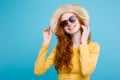 Travel concept - Close up Portrait young beautiful attractive redhair girl wtih trendy hat and sunglass smiling. Blue Royalty Free Stock Photo