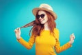 Travel concept - Close up Portrait young beautiful attractive redhair girl wtih trendy hat and sunglass smiling. Blue Royalty Free Stock Photo