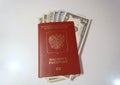 American dollars and foreign passport on the white background. Royalty Free Stock Photo