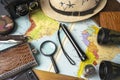 Travel concept, geographical map, magnifier and binoculars, hat and camera, travel background Royalty Free Stock Photo