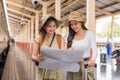 Travel concept. girl friend wear hat holding map have bag and luggage. female traveller waiting train at train station Royalty Free Stock Photo