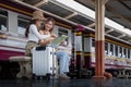 Travel concept. girl friend wear hat holding map have bag and luggage. female traveller waiting train at train station Royalty Free Stock Photo