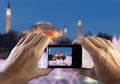 Travel concept. Hands making photo of night city with smartphone camera. Istanbul at sunset. Turkey Royalty Free Stock Photo