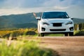 Travel Concept. Happy Traveler Woman Driving her Car on the Road. Raise hand and Smiling, Beautiful Foliage and Mountains Hills as