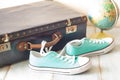 Travel concept with holiday suitcase, shoes and globe Royalty Free Stock Photo