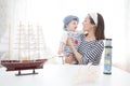 Travel concept. Mother and her child boy making model ship. Royalty Free Stock Photo